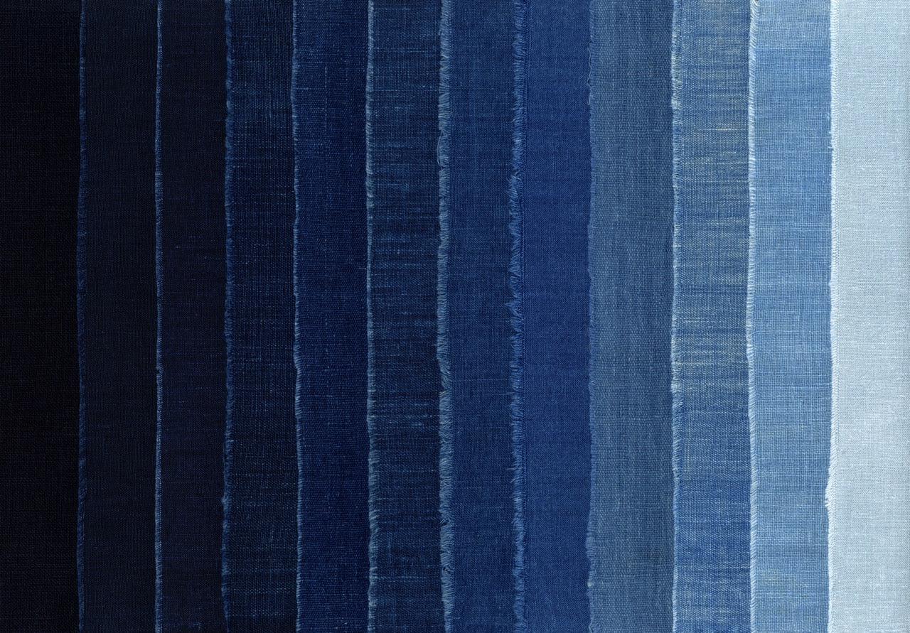 Indigo shibori hand-dyed fabric with traditional Japanese tie-dye patterns in deep blue tones