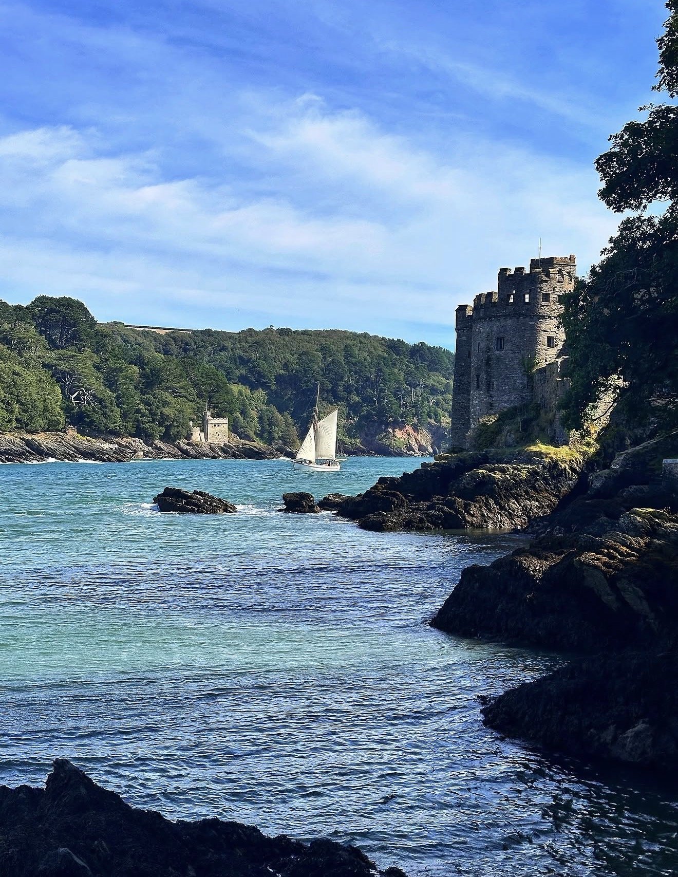 Dartmouth Castle perched above the water with the River Dart estuary in the background